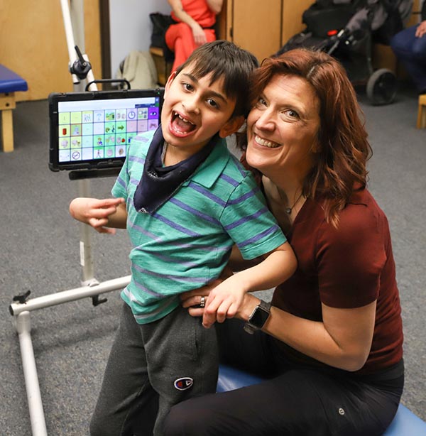 Image of woman and boy with speech device