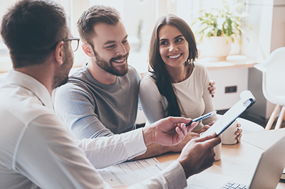 couple with consultant looking over paperwork